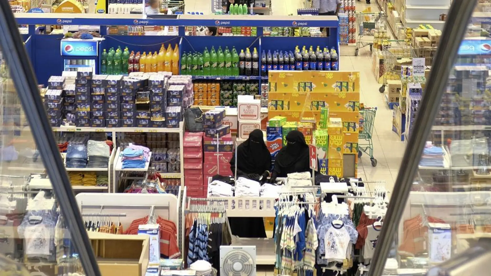 Cataríes acuden a un supermercado para comprar alimentos ante el temor de un posible desabastecimiento.