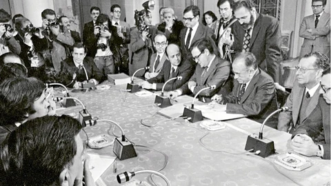 La mesa de negociaciones de los Pactos de la Moncloa. De izquierda a derecha: Adolfo Suárez, Fernando Abril Martorell, Francisco Fernández Ordoñez, Ramón Tamames, Santiago Carrillo, Tomás García (Juan Gómez) y Jordi Solé Tura. En el lado izquierdo, parcialmente, Felipe González.