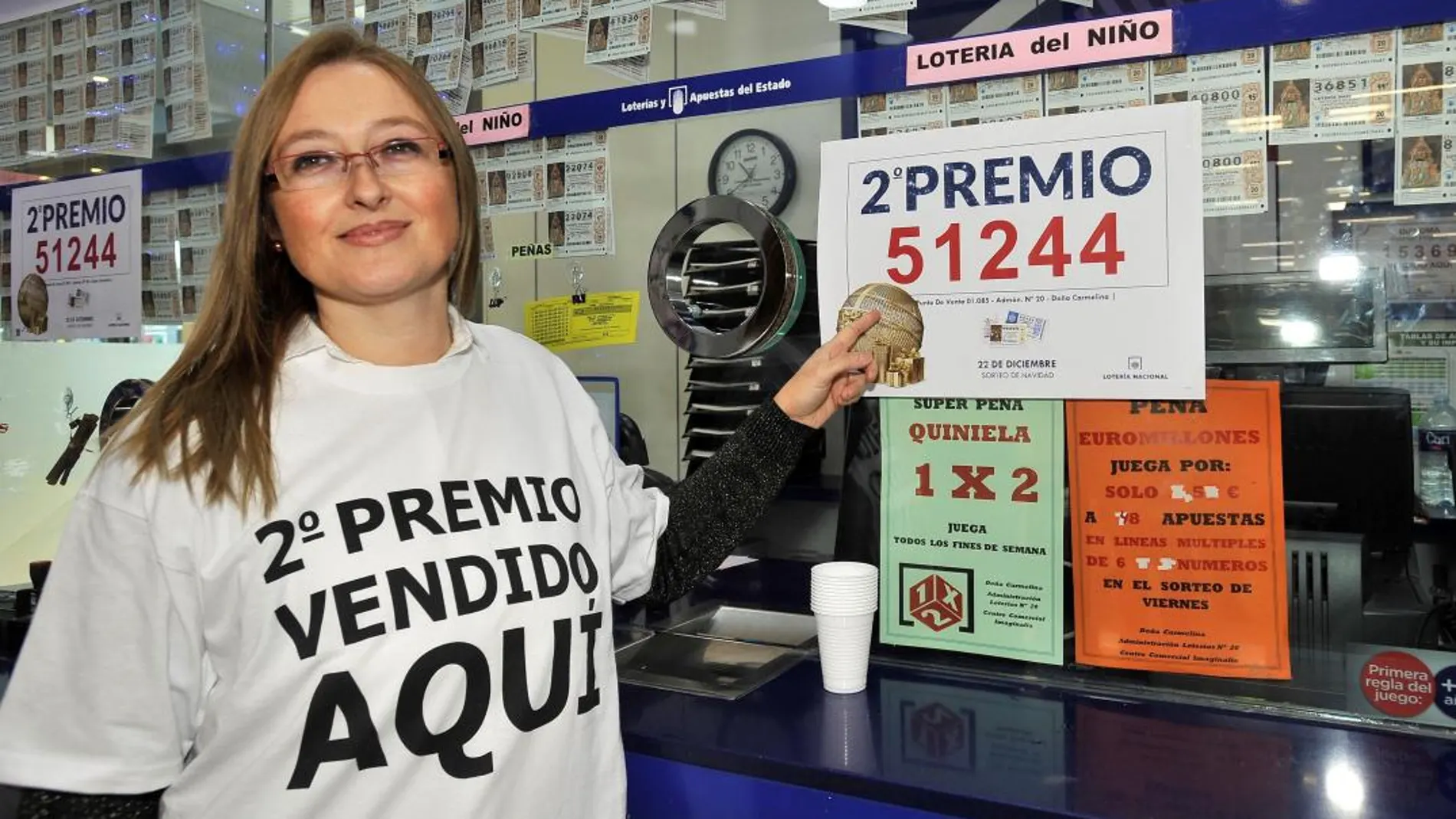 La responsable de la administración nº 20 de Albacete muestra el cartel del segundo premio del Sorteo Extraordinario de la Lotería de Navidad, el 51.244