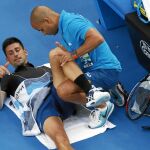 Novak Djokovic es tratado por su entrenador en la tercera ronda del torneo australiano