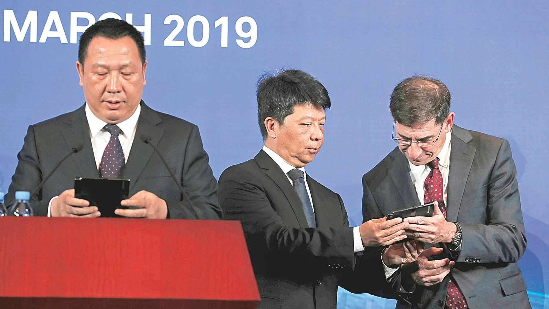 El presidente rotatorio de Huawei conversa con el socio Glen Nager mientras el jefe legal de la compañia comparece ante la Prensa ayer en Shenzhen