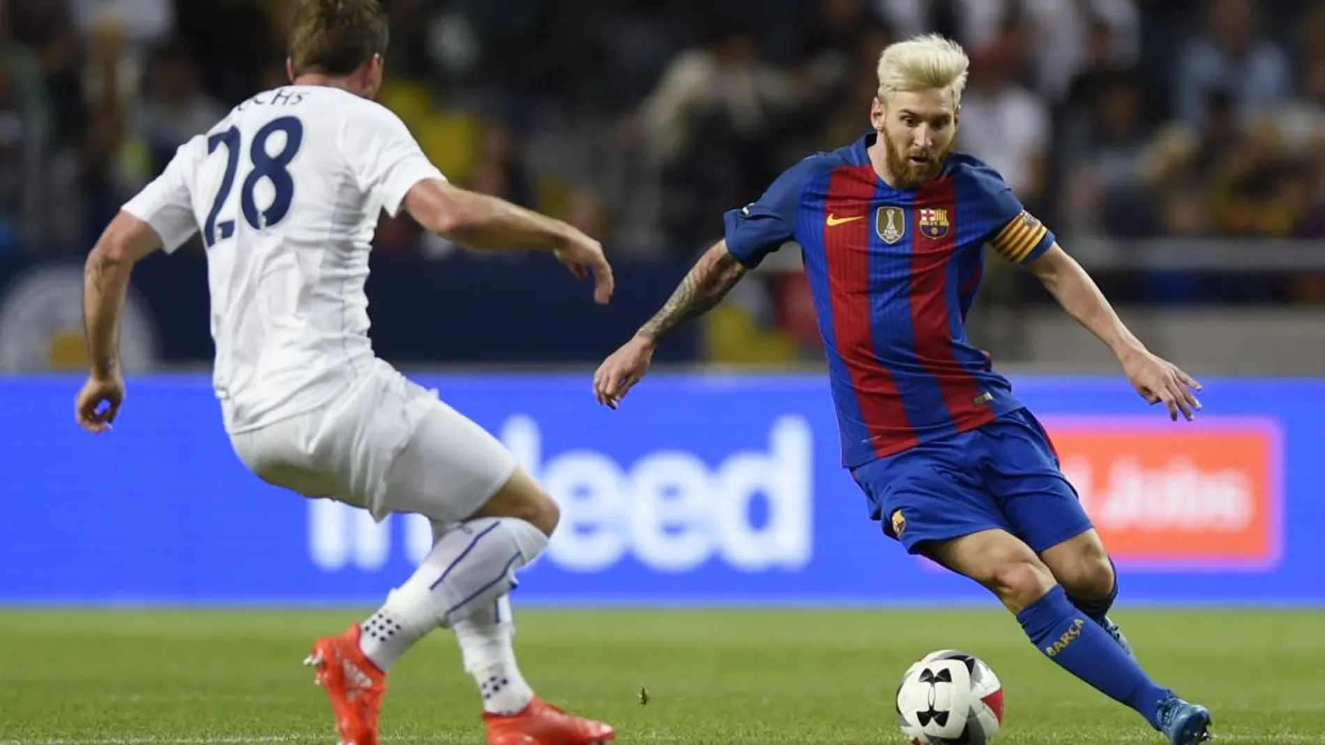 El jugador del Leicester City, Christian Fuchs lucha por el balón con el delantero argentino Leo Messi (C) del FC Barcelona