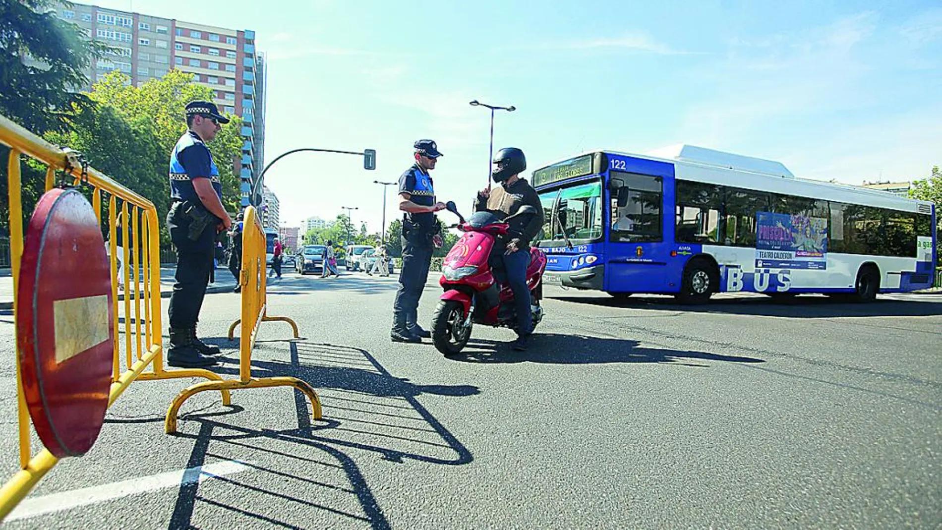 Dos policías locales de Valladolid explican a un motorista el motivo del cierre al tráfico de las calles del centro.