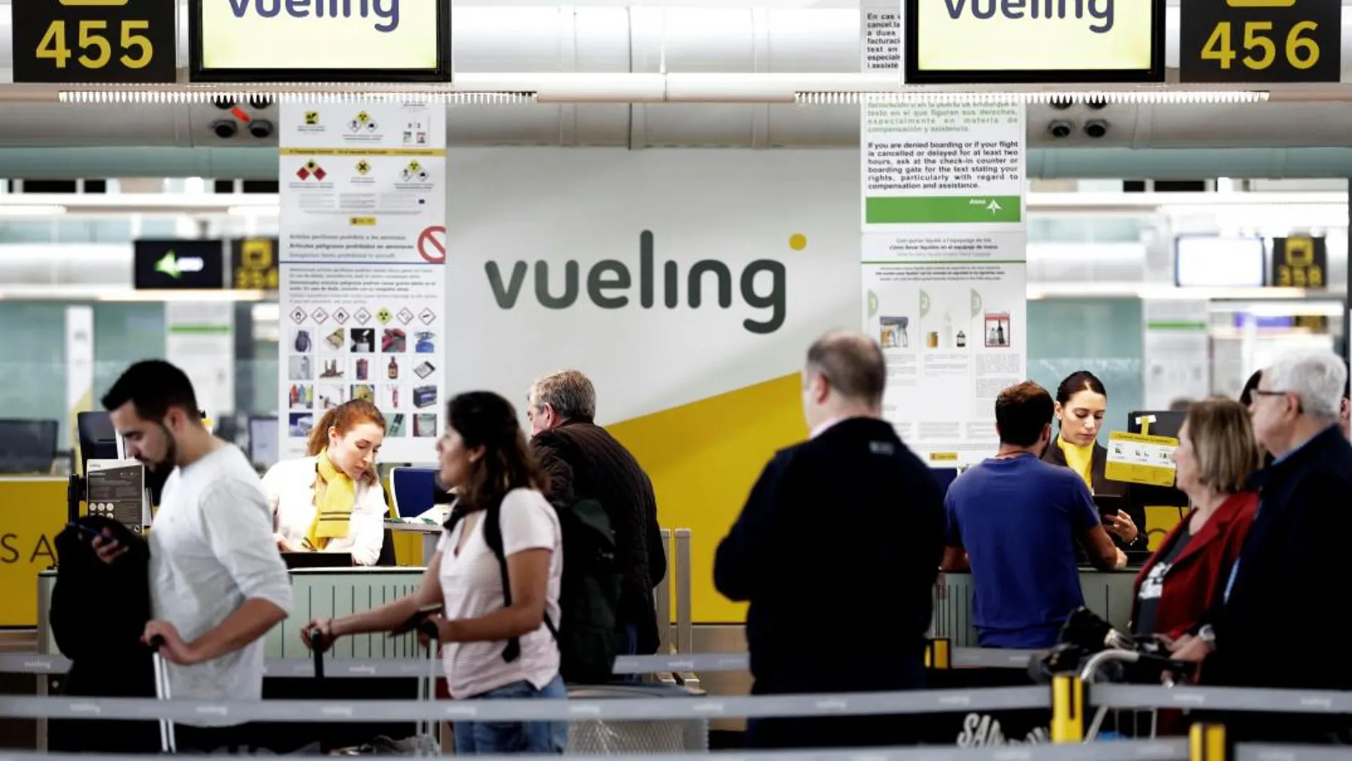Un grupo de pasajeros ante un mostrador de facturacion de Vueling en el Aeropuerto de Barcelona-El Prat / Foto: Efe