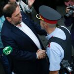 El vicepresidente de la Generalitat, Oriol Junqueras, saluda a un mosso a su llegada Escuela Sant Jordi de Barcelona para votar en el referéndum sobre la independencia de Cataluña