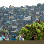 Vecinos de la favela Rocinha en Rio de Janeiro hacen cola para votar en un colegio electoral, ayer / Efe