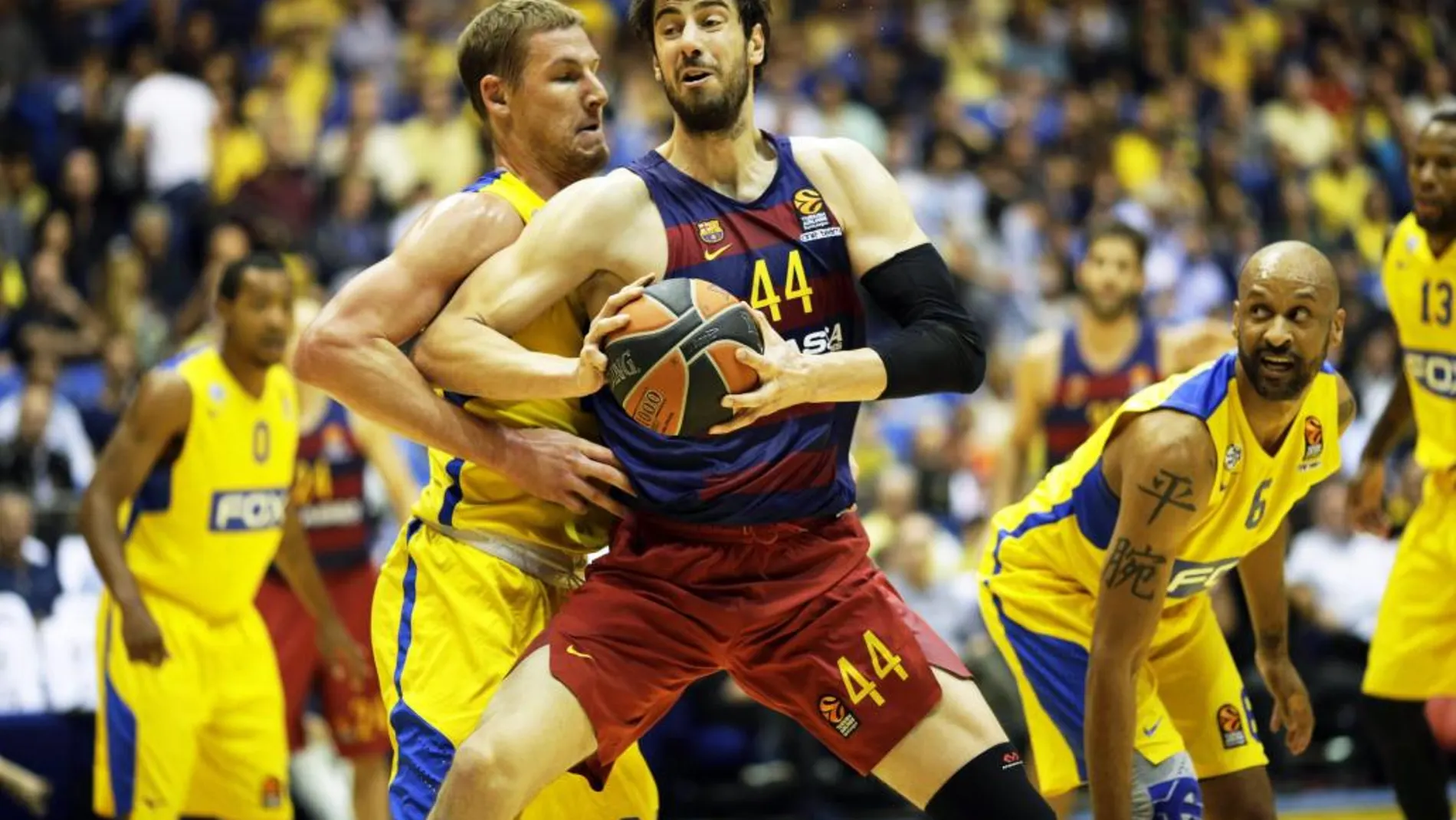 El jugador de baloncesto croata del Barcelona, Ante Tomic (i), lucha por el balón con el estadounidense del Maccabi Electra Tel Aviv, Colton Iverson (d)