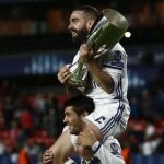 Los jugadores del Real Madrid Carvajal (arriba) y Morata llevan el trofeo tras vencer al Sevilla en la final de la Supercopa de Europa 2016 disputada esta noche en el estadio de Lerkendal, en la ciudad noruega de Trondheim.