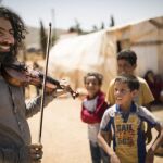 El violinista durante su visita a un campo de refugiados