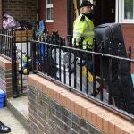 Policías británicos permanecen fuera de un bloque en una operación relacionada con los atentados de ayer.