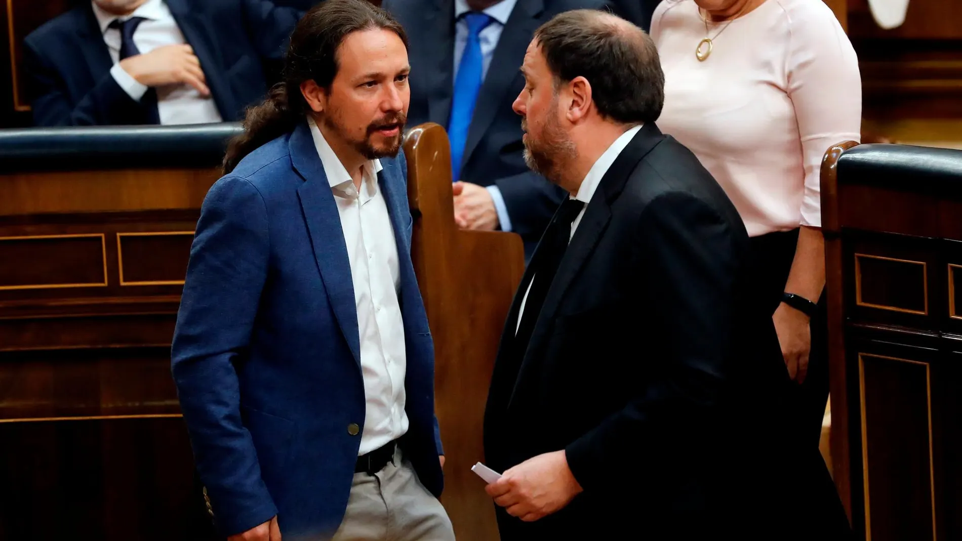 El líder de Podemos, Pablo Iglesias (i), conversa con el diputado electo en prisión preventiva de ERC Oriol Junqueras (d),