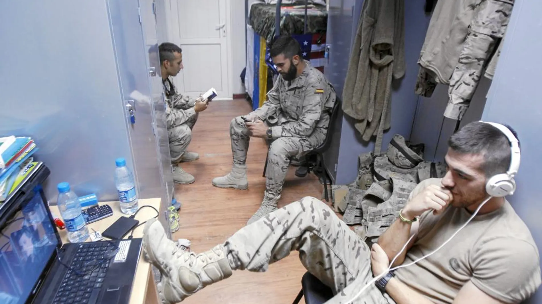 EN LA HABITACIÓN. Tres militares españoles de la base «Ruy González de Clavijo» descansan en su habitación con el ordenador y la lectura