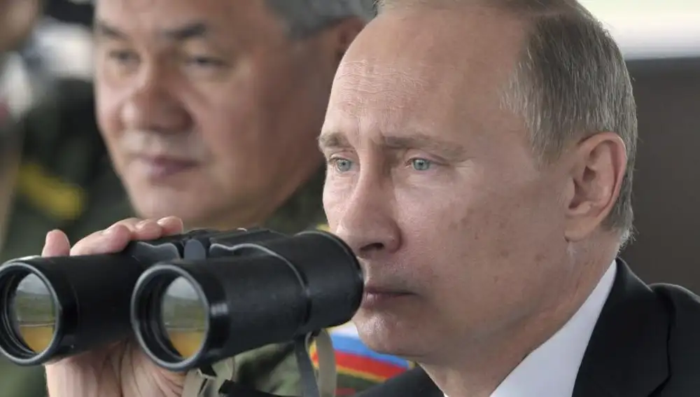El presidente ruso, Vladímir Putin (dcha), y el ministro de Defensa, general Serguéi Shoigu, observan maniobras militares en la base de entrenamiento de Uspenovsky, en la región de Sajalín