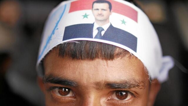 Un militante chíi, con una pañoleta de Asad en la cabeza