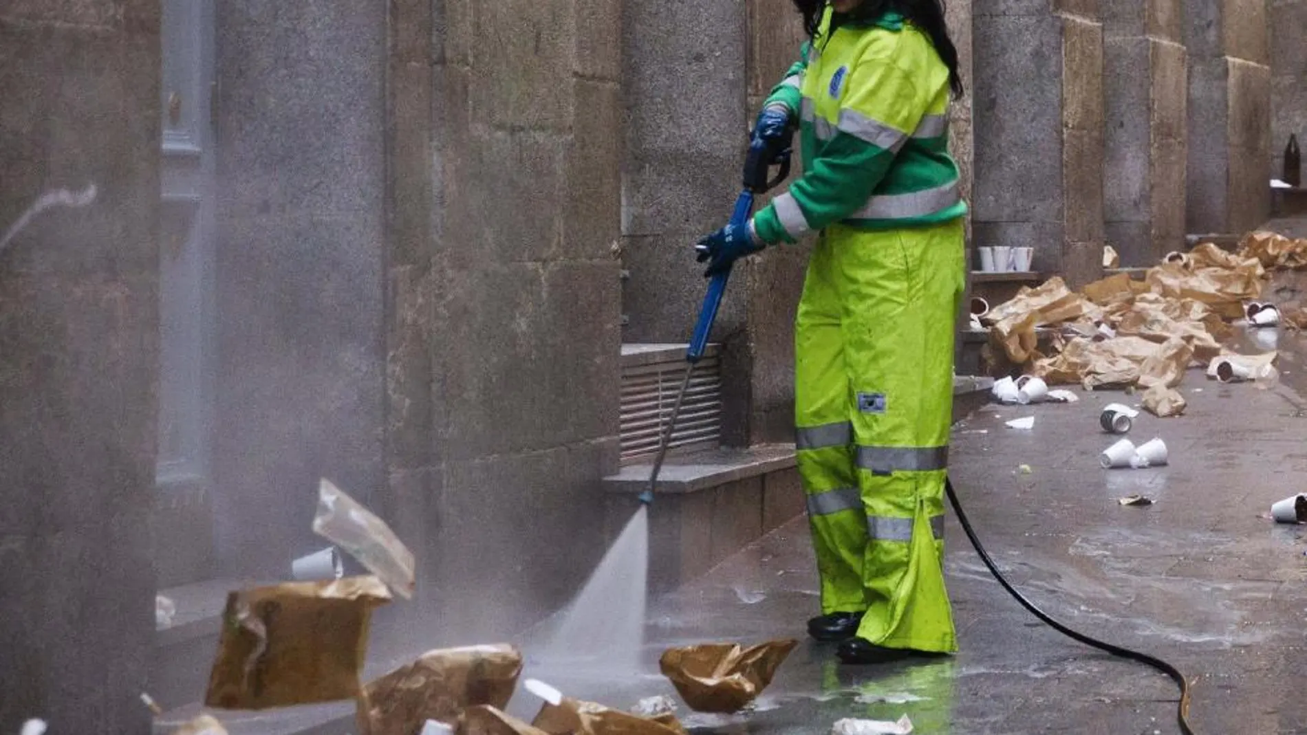 Una empleada de los servicios de limpieza realiza su trabajo en el pasadizo de San Ginés, en las inmediaciones de la madrileña Puerta del Sol