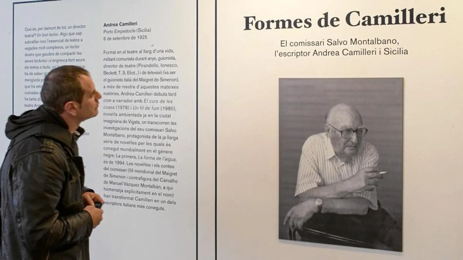 Un visitante en la muestra de la Biblioteca Jaume Fuster contempla el retrato de Andrea Camilleri