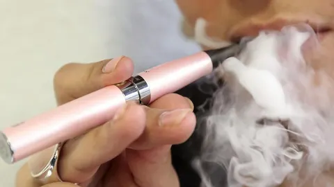 Mujer fumando un cigarrillo electrónico