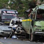A mini bus and passenger cars pilled up after the explosion in Nairobi, Kenya, Saturday, Dec. 14, 2013. Several people are feared dead and others injured in an explosion on a minibus in Nairobi's Pangani residential estate, the Kenyan police said on Saturday. (AP Photo) .