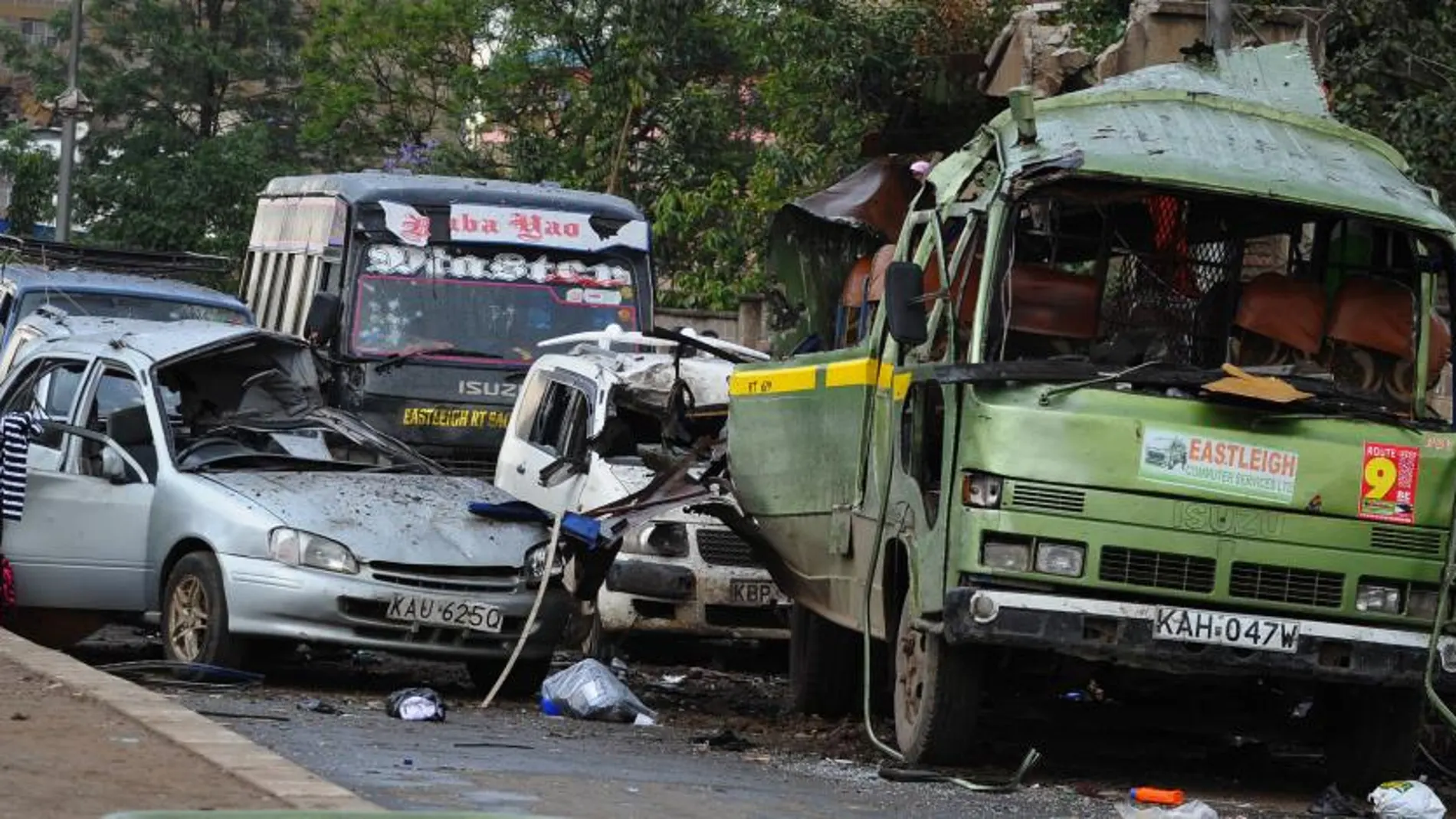 A mini bus and passenger cars pilled up after the explosion in Nairobi, Kenya, Saturday, Dec. 14, 2013. Several people are feared dead and others injured in an explosion on a minibus in Nairobi's Pangani residential estate, the Kenyan police said on Saturday. (AP Photo) .