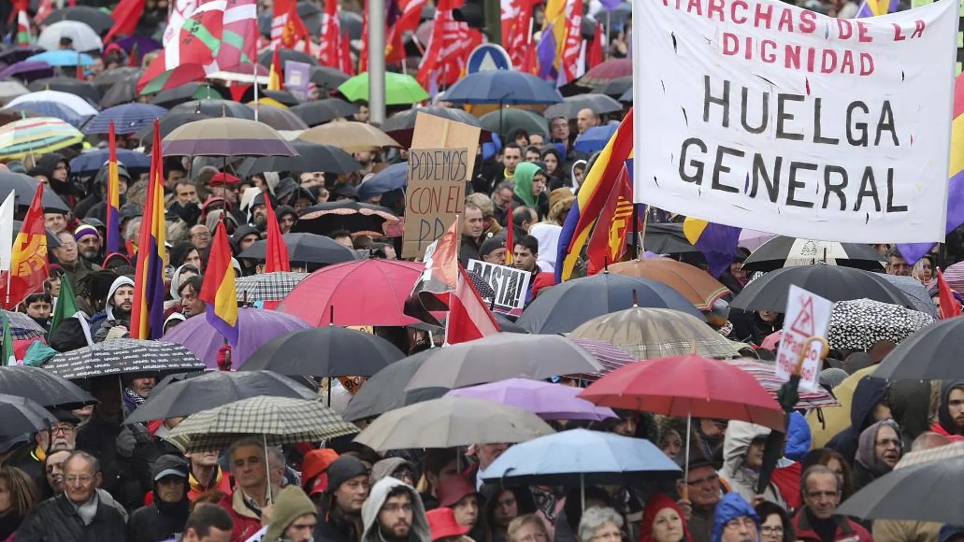 Miles de participantes en las Marchas por la Dignidad con sus paraguas inundan la Plaza de Colón.