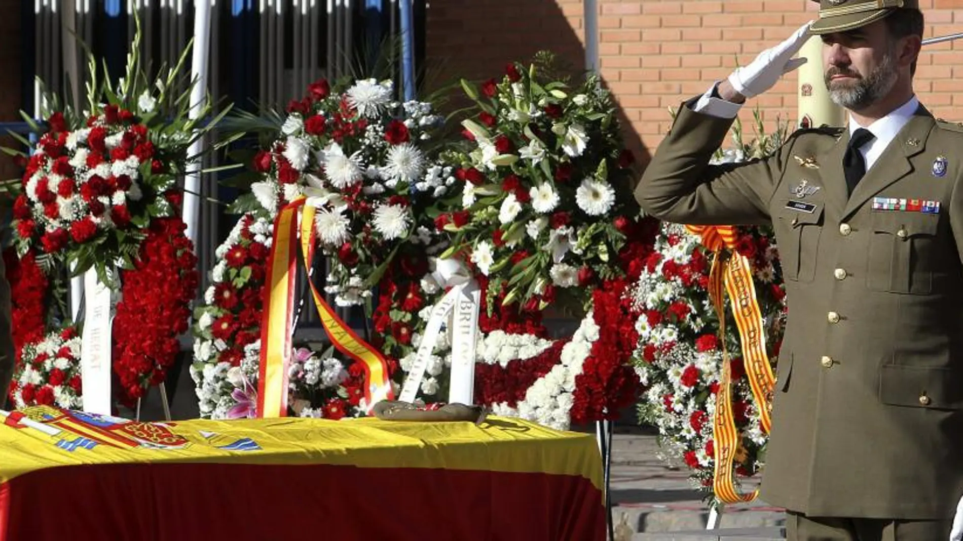 El Príncipe Felipe saluda militarmente tras imponer la Cruz al Mérito Militar con distintivo rojo a título póstumo al sargento David Fernández Ureña, fallecido el día 11 en Afganistán