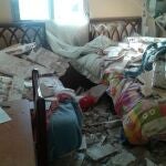 Imagen de una de las habitaciones afectadas con las camas llenas de escombros.