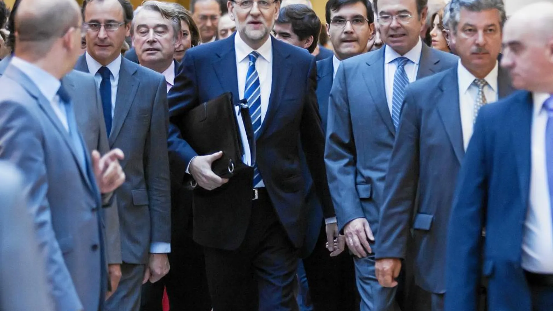 Mariano Rajoy, arropado por dirigentes de su partido, en los pasillos del Senado
