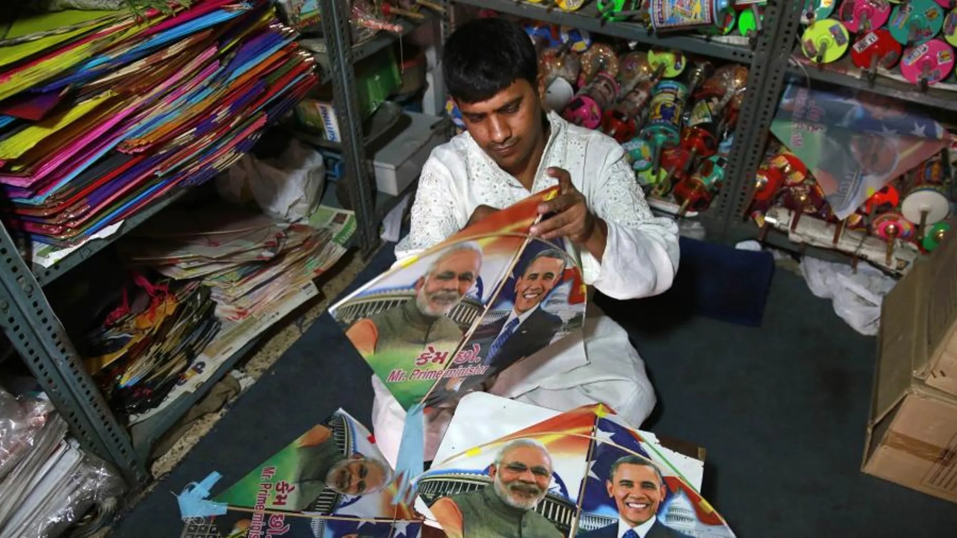 Un tendero prepara banderines con los retratos del primer ministro, Narendra Modi, y el presidente estadounidense, Barack Obama