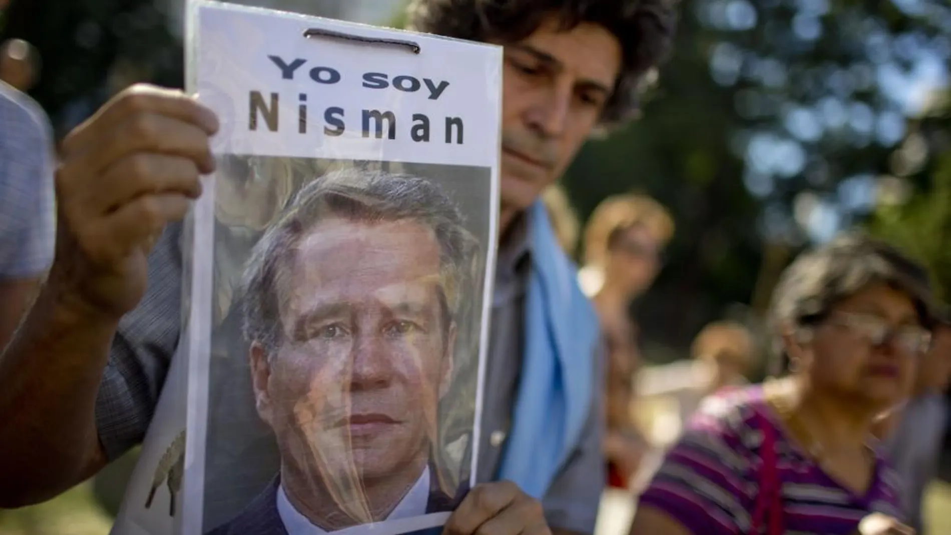 Un hombre sostiene una foto del fiscal argentino Alberto Nisman durante una concentración en su memoria/AP