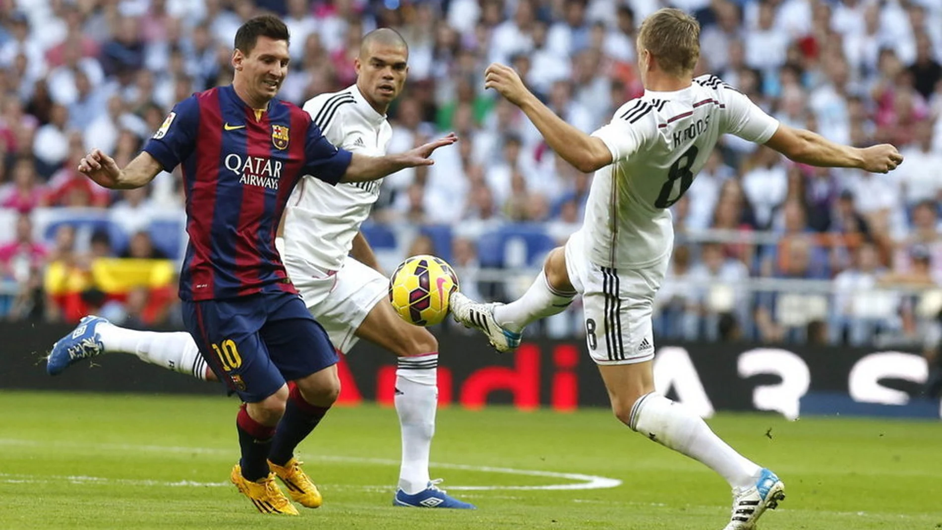 Kroos y Messi disputan un balón con Messi