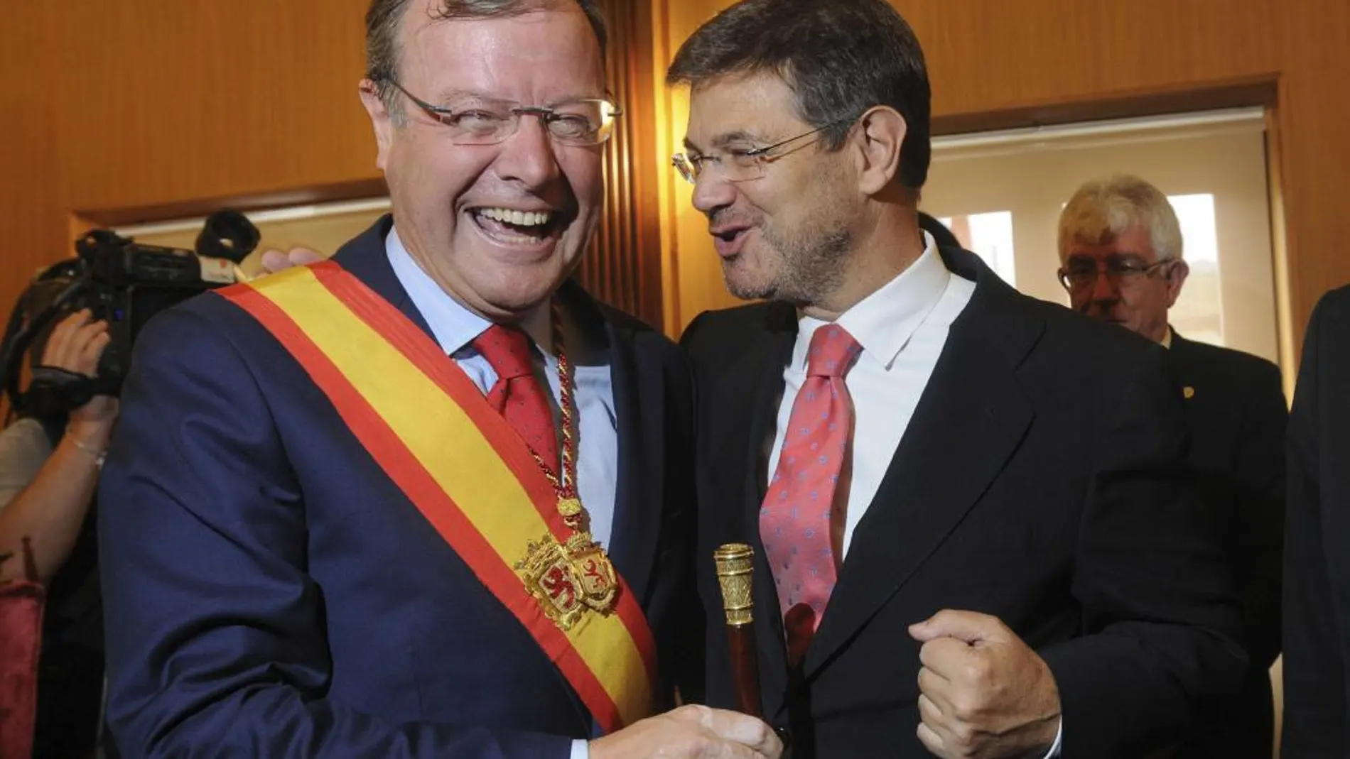 El ministro de Justicia Rafael Catalá (d) felicita al alcalde de León Antonio Silván tras su toma de posesión del cargo.