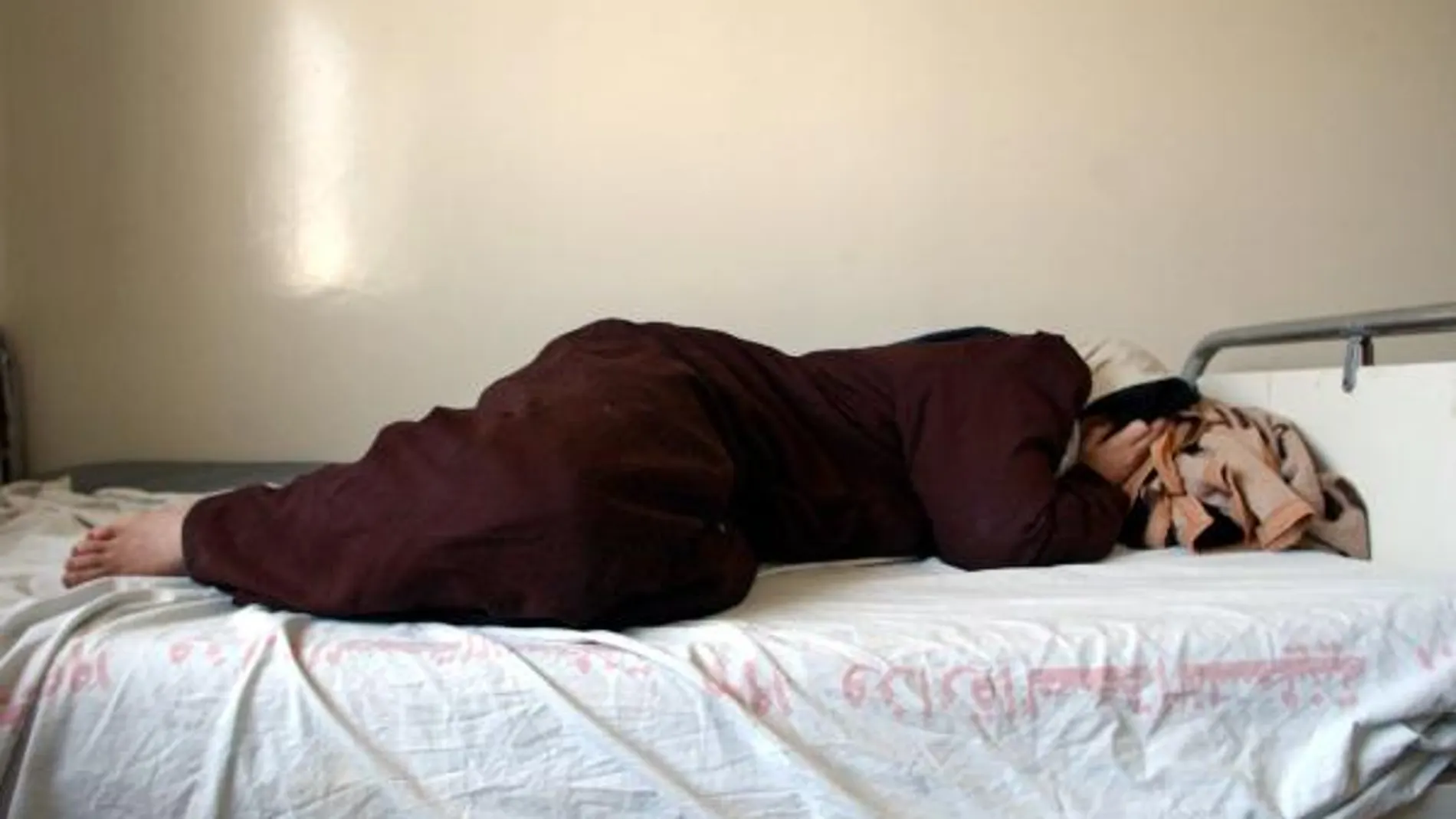 Una mujer deprimida tumbada en la cama. Fuente: AP