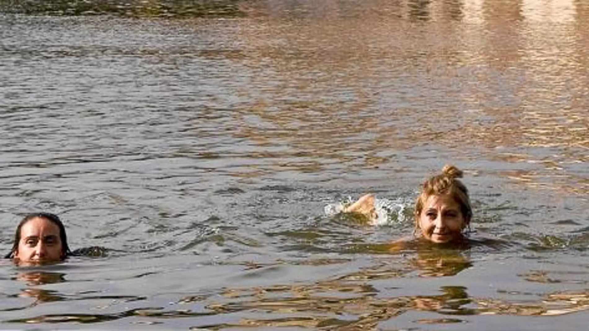 Dos mujeres se bañan, en las aguas del río Duero a su paso por Zamora, para calmar el calor de la jornada de ayer