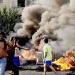 Un grupo de jóvenes protesta ayer en Sidon por el brutal atentado que terminó con la vida del general Hasan