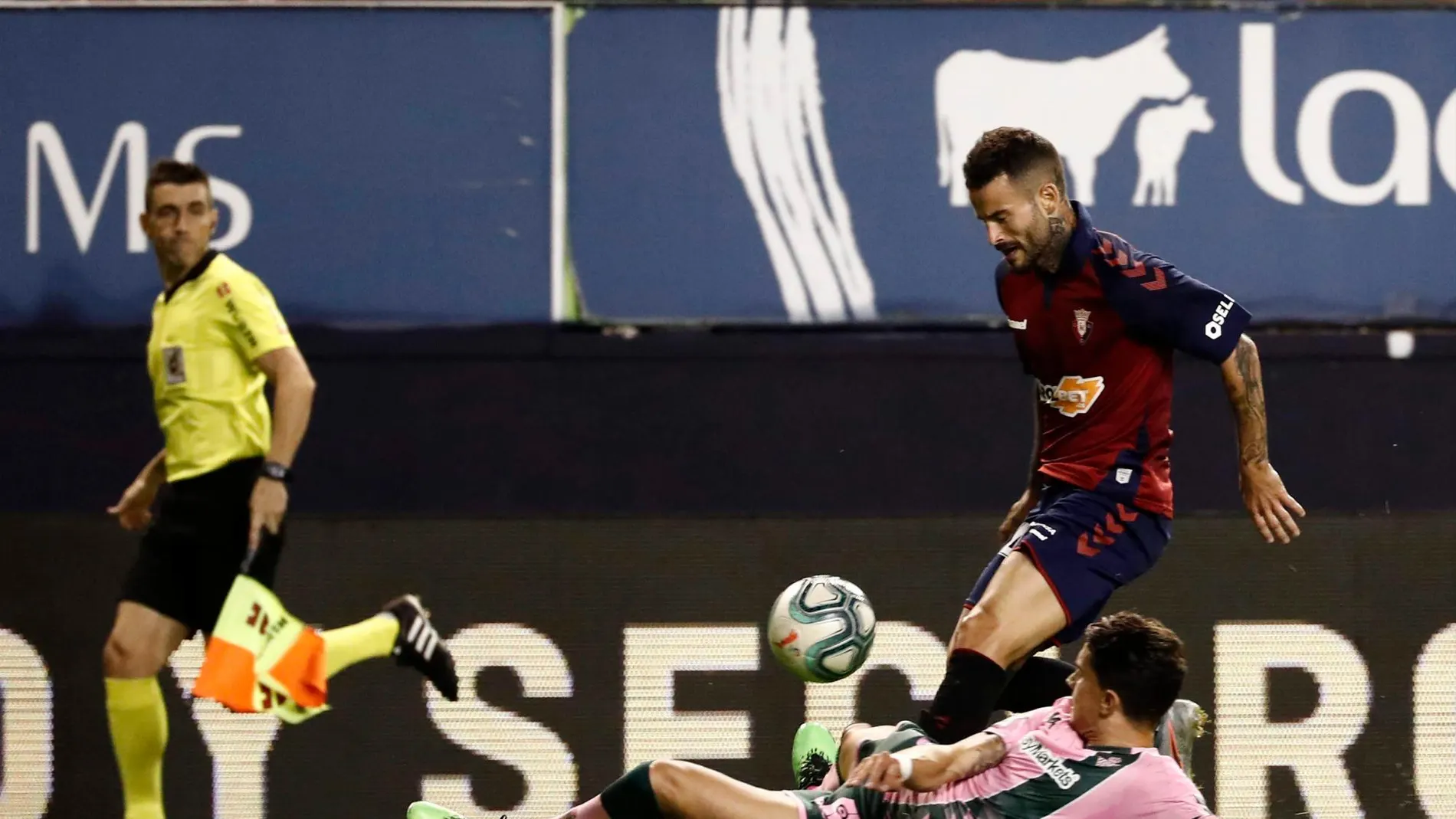 El jugador de Osasuna Rubén García se lleva la pelota ante Marc Bartra, defensa del Betis