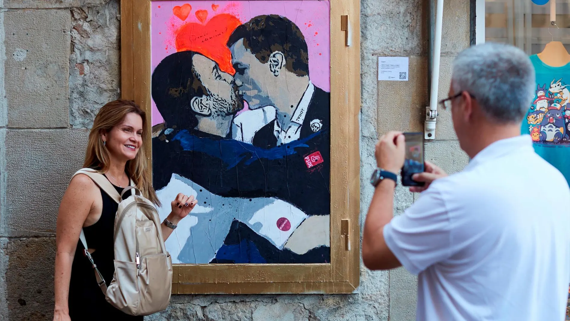 El artista urbano TVBoy plasmó en una pared del centro de Barcelona su última obra, que muestra al presidente en funciones socialista, Pedro Sánchez, y al líder de Unidas Podemos, Pablo Iglesias, fundiéndose en un beso