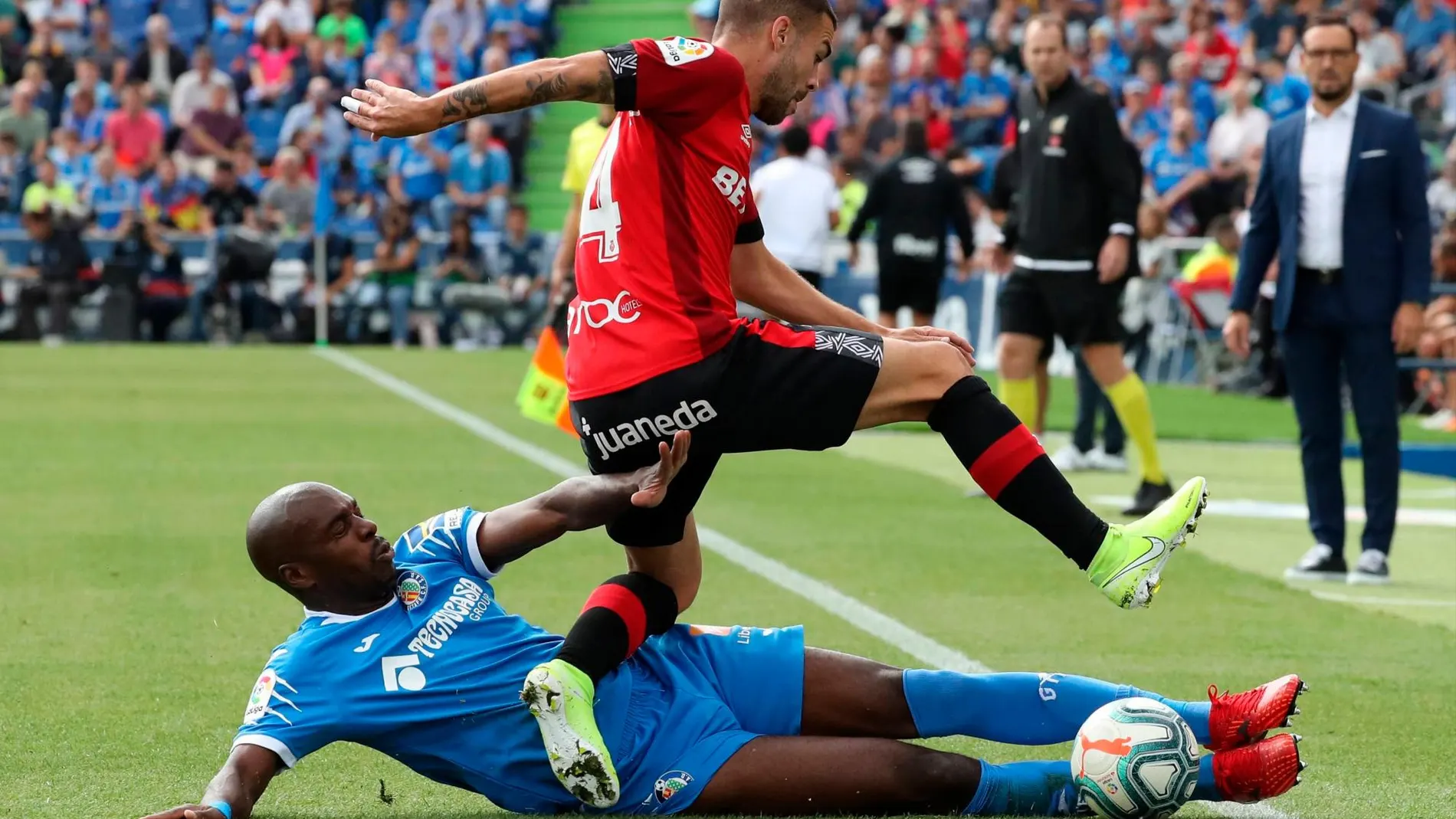 El jugador Daniel Rodríguez (d), del Mallorca, disputa un balón con Allan Nyom (i) del Getafe