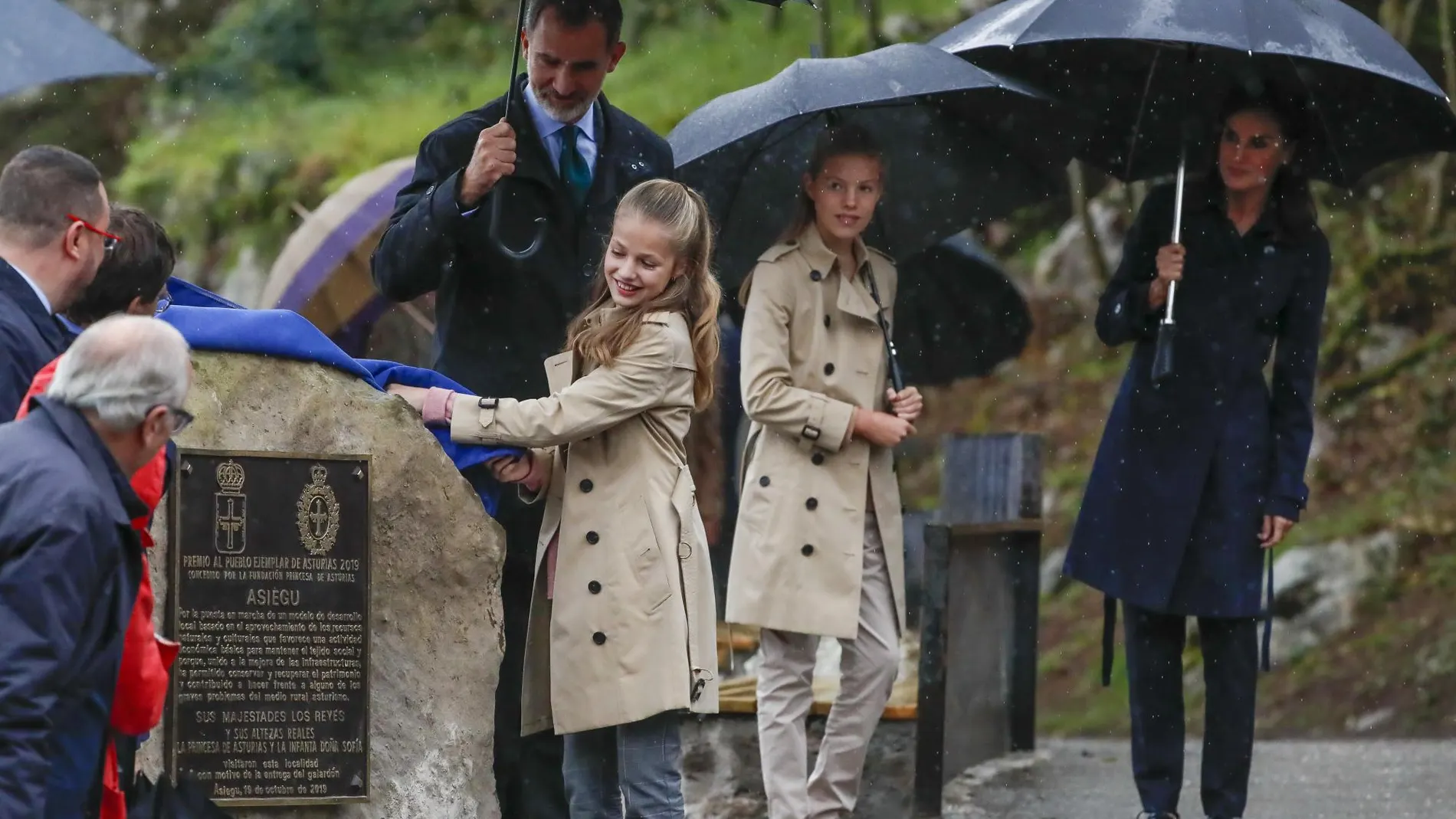 La Reina Letizia y sus hijas apuestan por la gabardina en una mañana lluviosa en Asiegu
