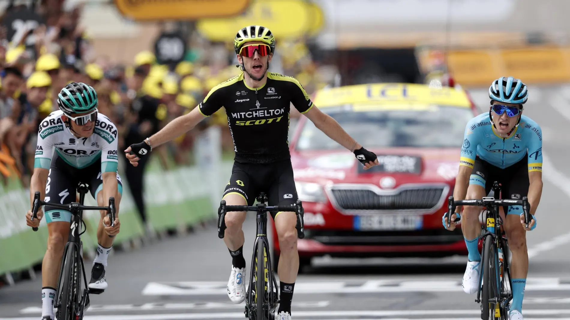 [and Austria's Gregor Muhlberger, celebrates as he crosses the finish line to win the twelfth stage of the Tour]