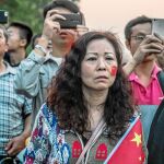 Ciudadanos chinos observan ayer el izado de la bandera nacional en la Plaza de Tiananmen, en Pekín / Efe