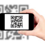 Scanning QR code with mobile smart phone. Isolated on white.