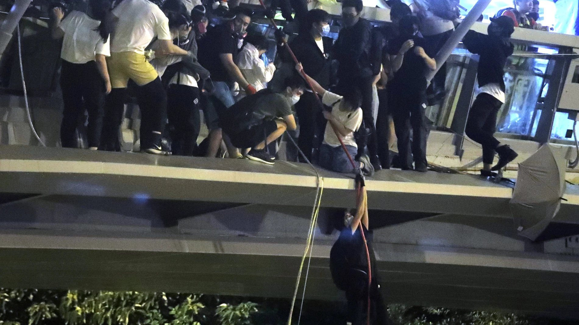 Un manifestante intenta huir de la Universidad Politécnica de Hong Kong
