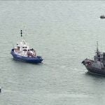 This video grab provided by the Krym 24 tv station via AP Television shows a seized Ukrainian ship, right, is towed by a Russian coast guard boat out of the port in Kerch, Crimea, Sunday, Nov. 17, 2019. Russia's Foreign Ministry says three Ukrainian naval ships that were seized in a shooting confrontation nearly a year ago have been returned. (Krym 24 tv station via AP Television)
