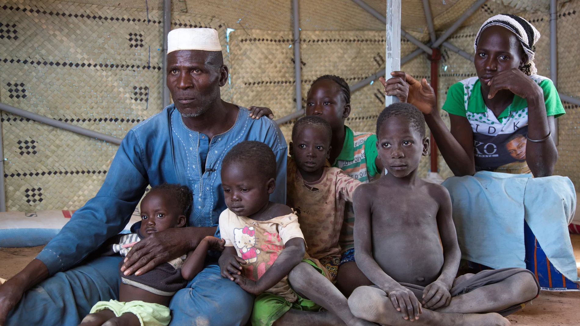 Zore Yusef sits with his family at an IDP camp in Pissila
