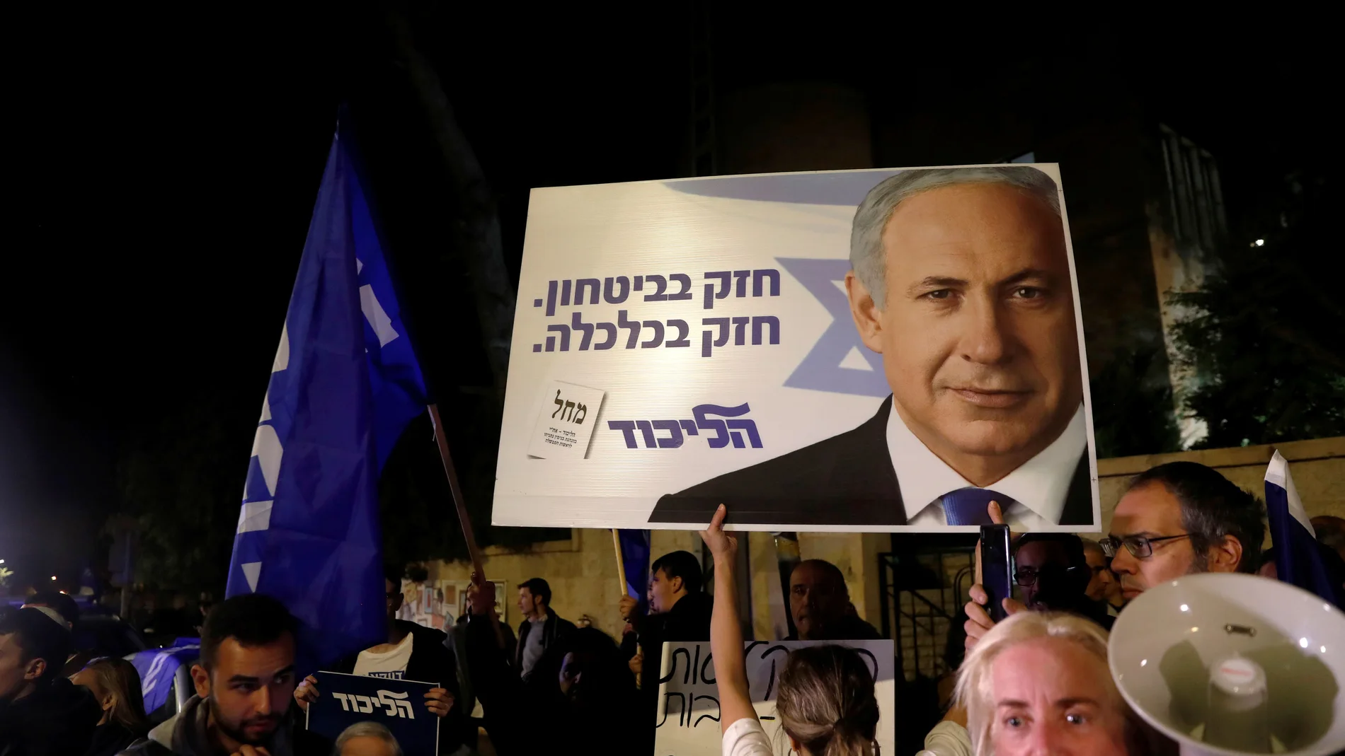 Supporters of Israeli Prime Minister Benjamin Netanyahu protest outside his residence following Israel's Attorney General Avichai Mandelblit's indictment ruling in Jerusalem
