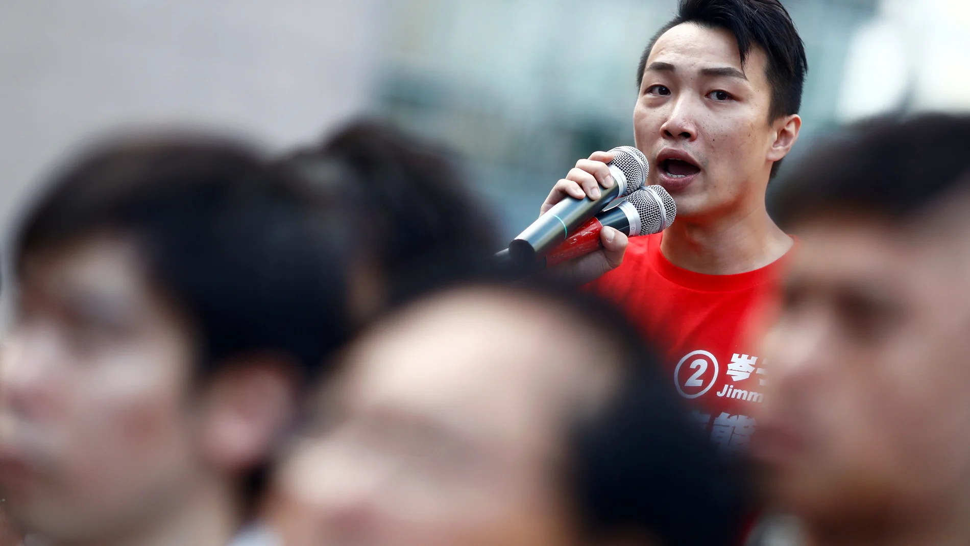 Pro-democratic district councilor-elect Jimmy Sham speaks to supporters at the campus of the Polytechnic University (PolyU) in Hong Kong