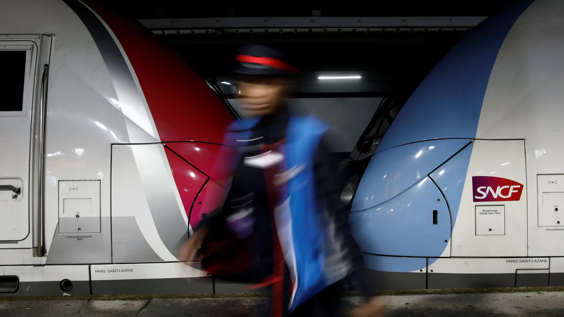An employee of French national railway operator SNCF is seen at the railway station in Asnieres-sur-Seine, near Paris