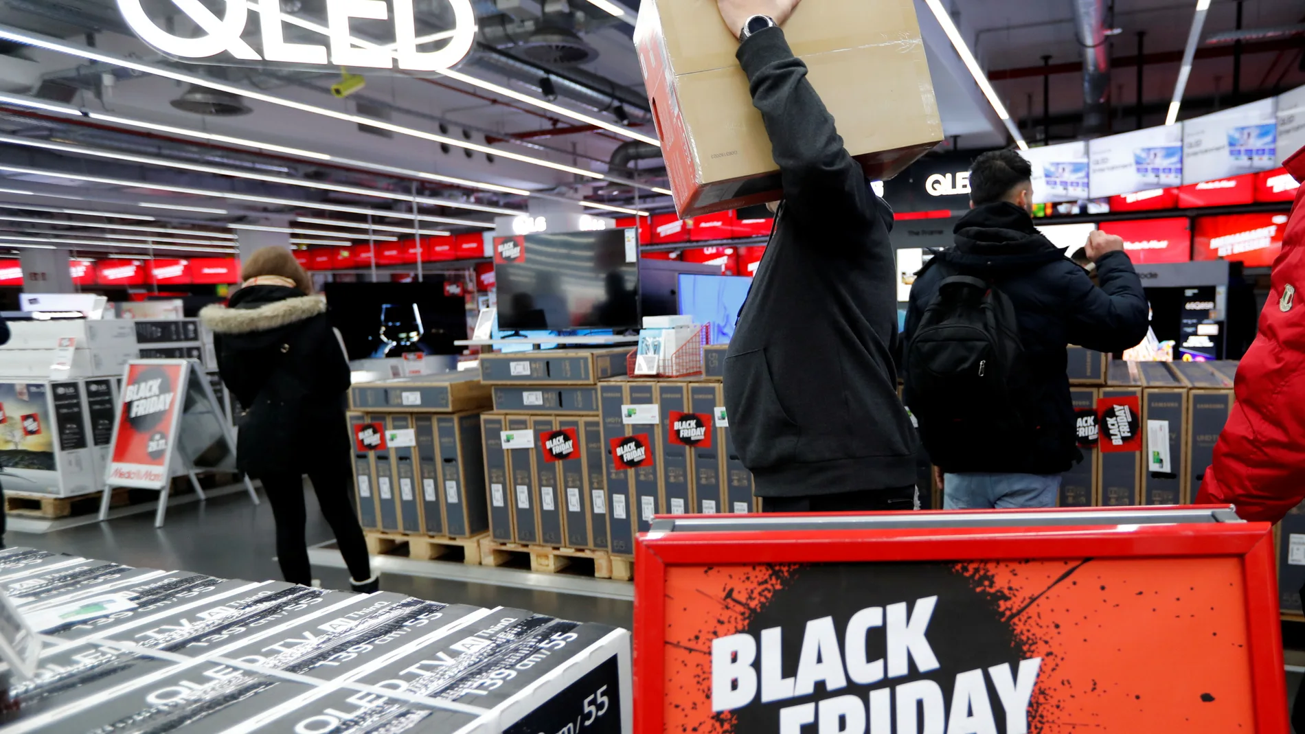 People shop during Black Friday deals at consumer electronics retailer Media Markt near Alexander Platz square in Berlin