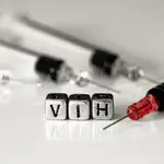 Syringes and blood with the word HIV on beads