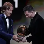 Barcelona&#39;s soccer player Lionel Messi, right, receives his sixth golden ball from Real Madrid&#39;s Lucas Modric during the Golden Ball award ceremony in Paris, Monday, Dec. 2, 2019. (AP Photo/Francois Mori)